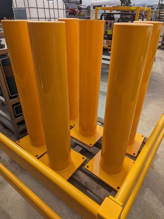 A Bunch of Yellow Poles Are Stacked on Top of Each Other — Eddies Trailers & Fab in Mudgee, NSW