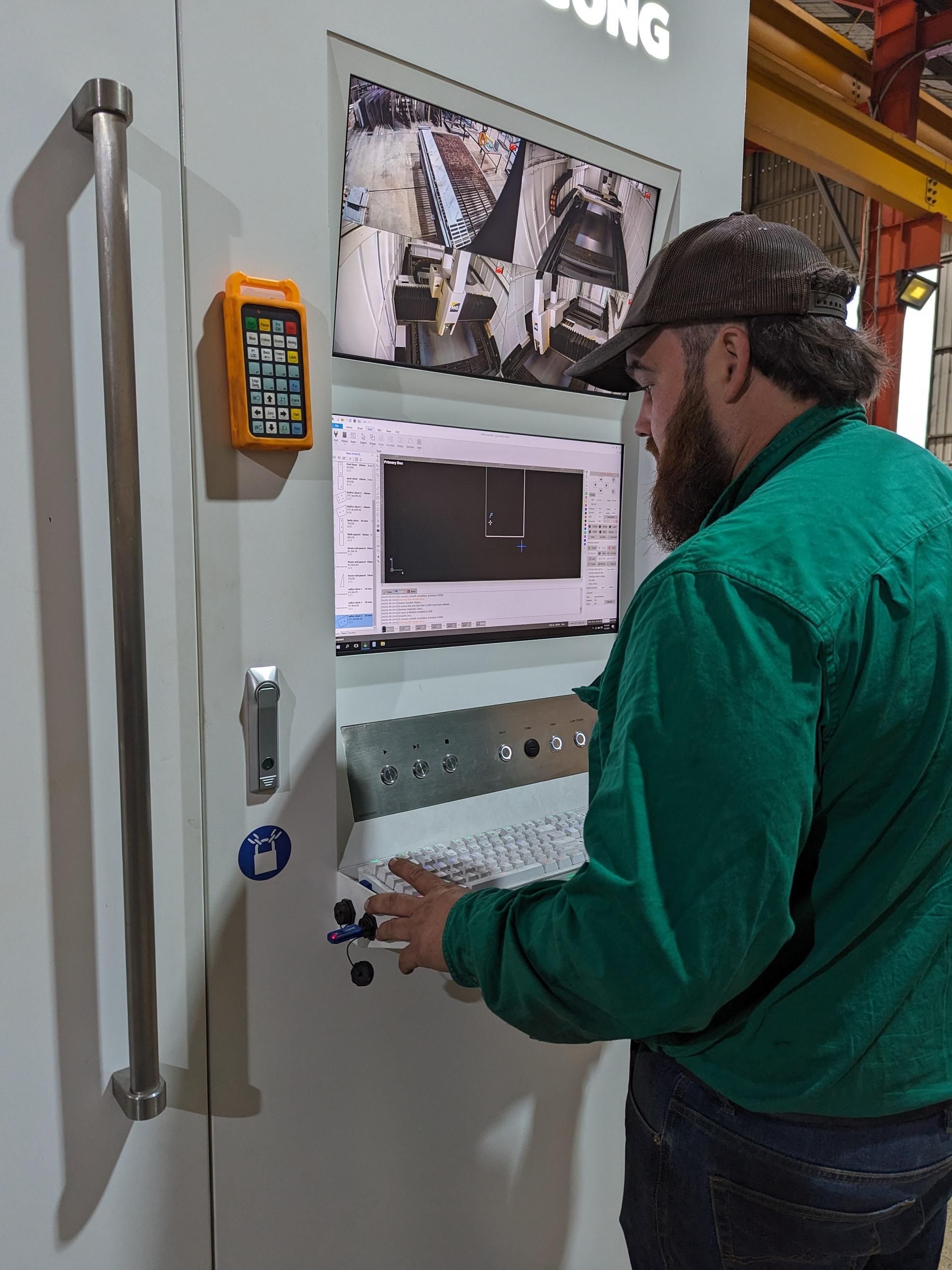 Man in Green Shirt Using Laser Cutter — Eddies Trailers & Fab in Muswellbrook, NSW
