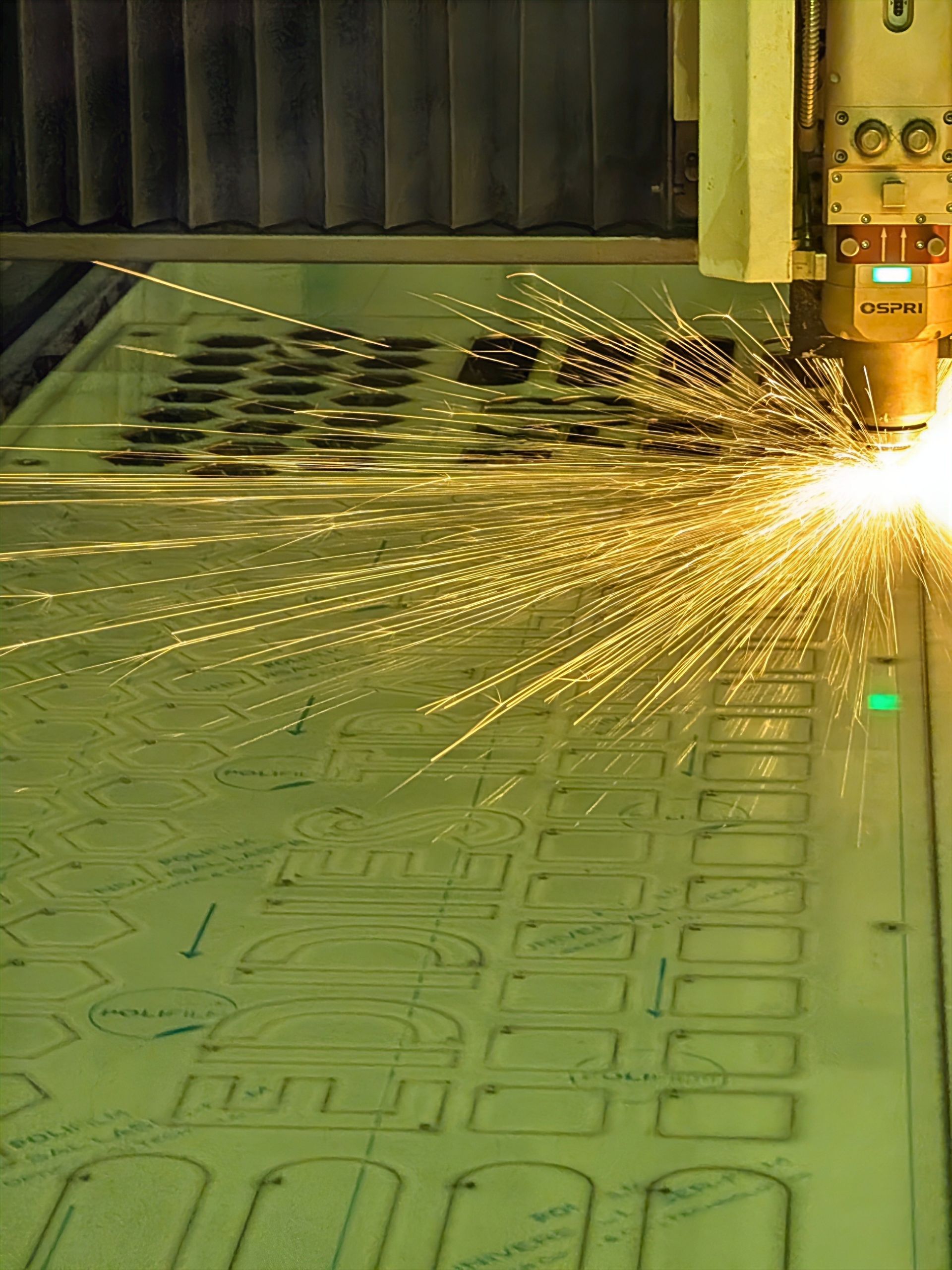 A Machine Is Cutting a Piece of Metal in A Factory — Eddies Trailers & Fab in Muswellbrook, NSW