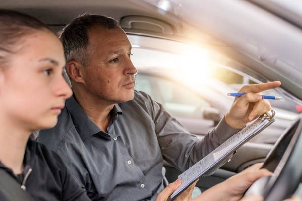 Young female having driving lessons from an instructor