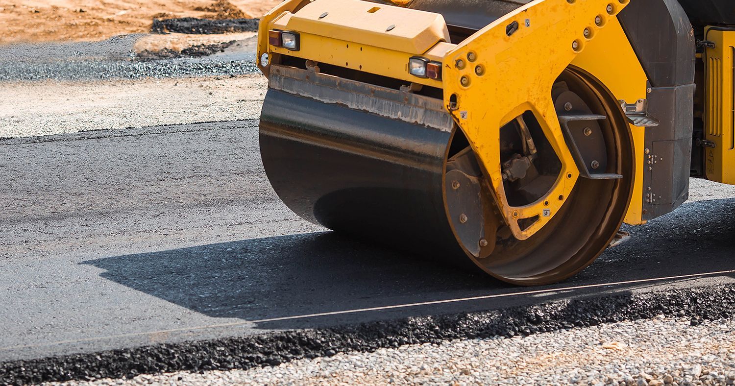 A road roller compacting asphalt for a smooth, durable surface. A road roller compacting asphalt for a smooth, durable surface.