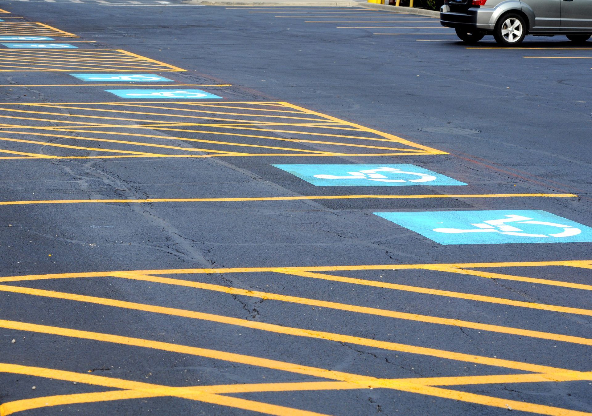 A car is parked in a handicapped parking spot