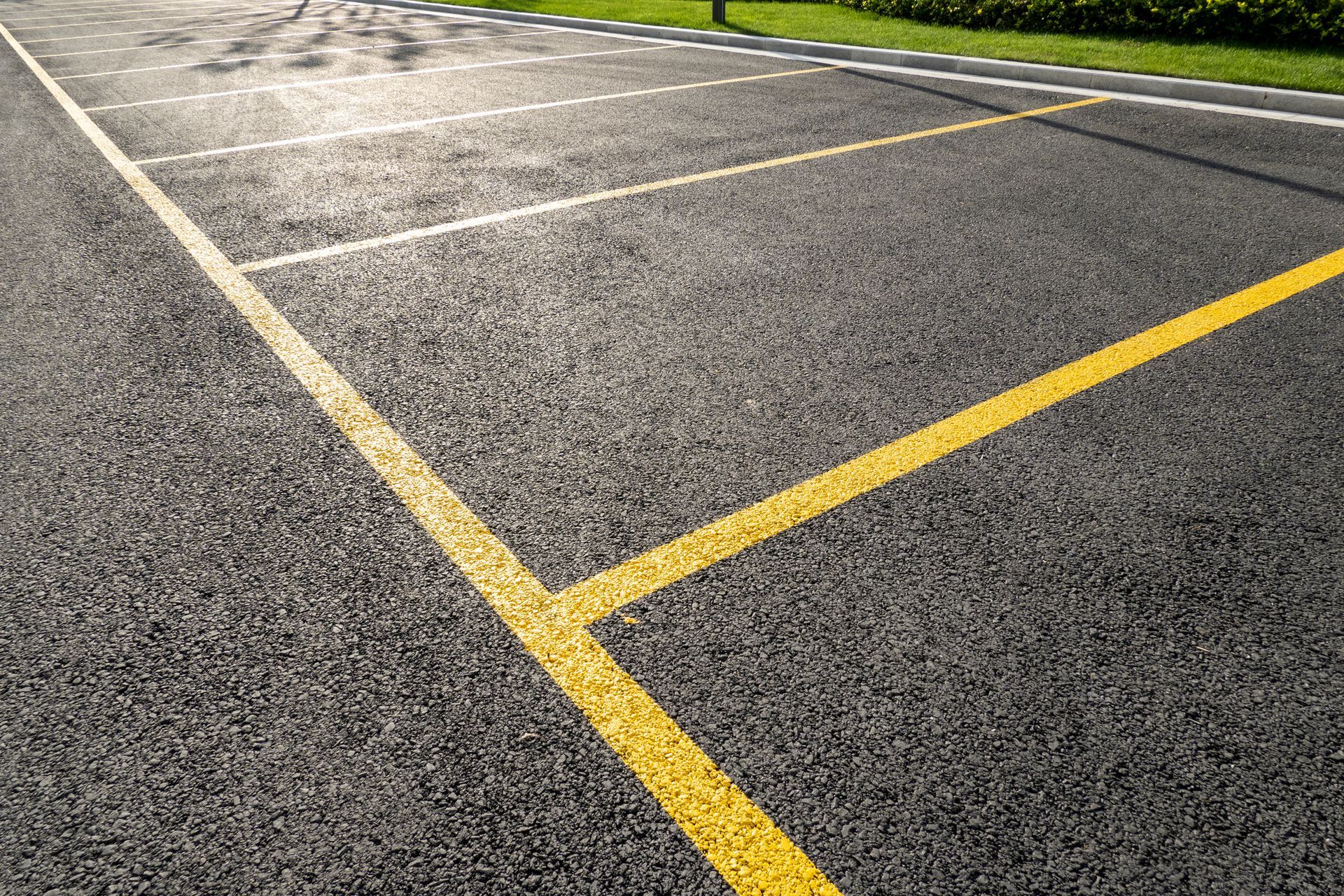 A parking lot with a yellow line on the side of it.