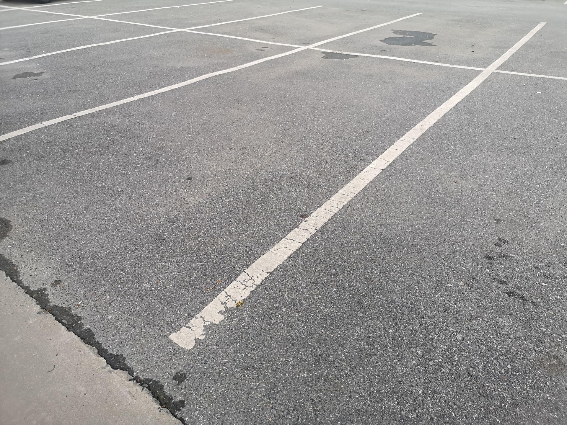 Parking lot with white painted lines on asphalt. Parking lot with white painted lines on asphalt.
