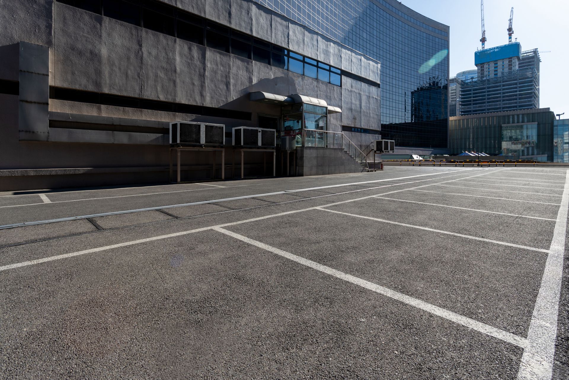 View of a commercial building’s parking lot and other buildings in the background