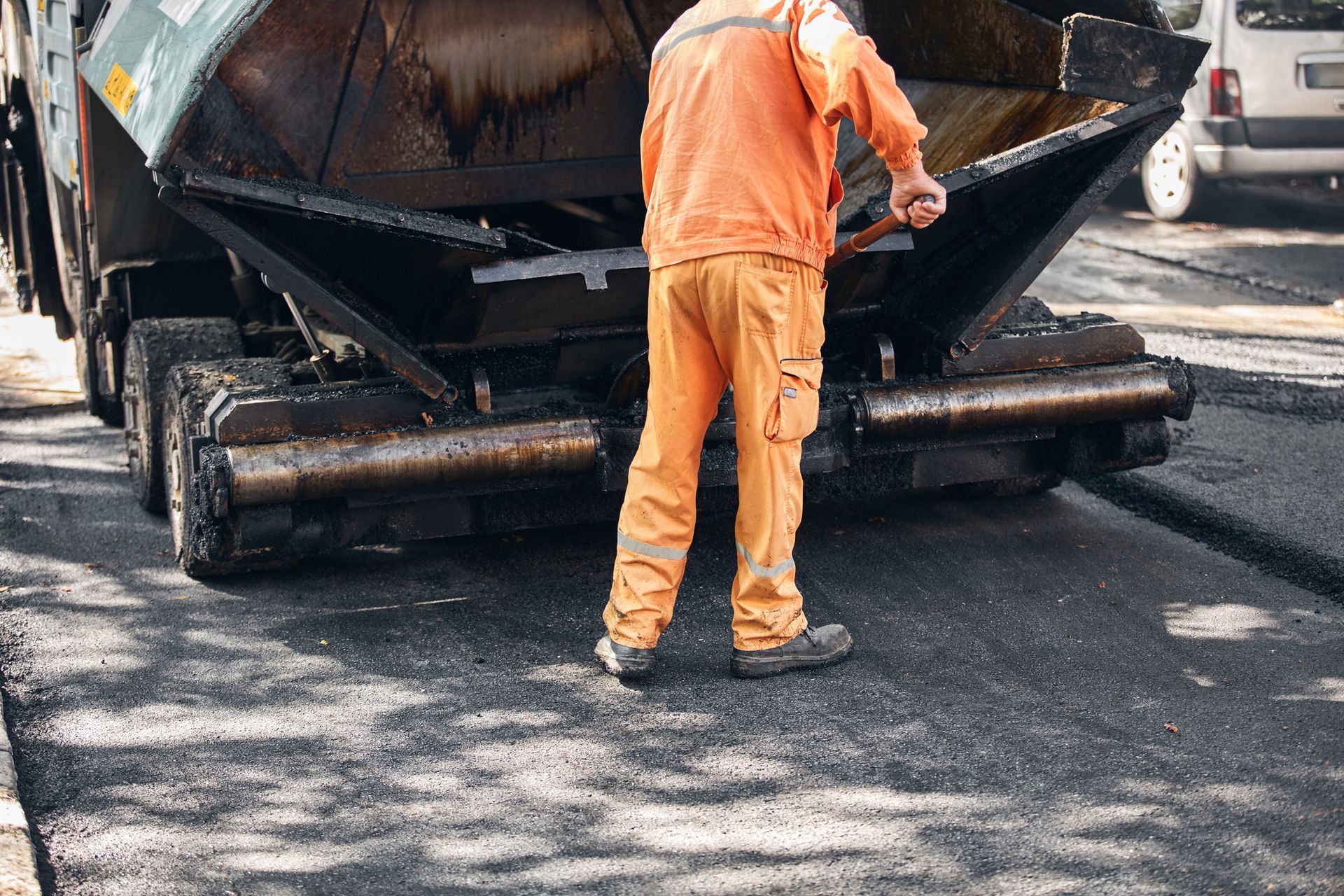 Commercial paving contractor working on a new asphalt layer on a public street. Commercial paving contractor working on a new asphalt layer on a public street.