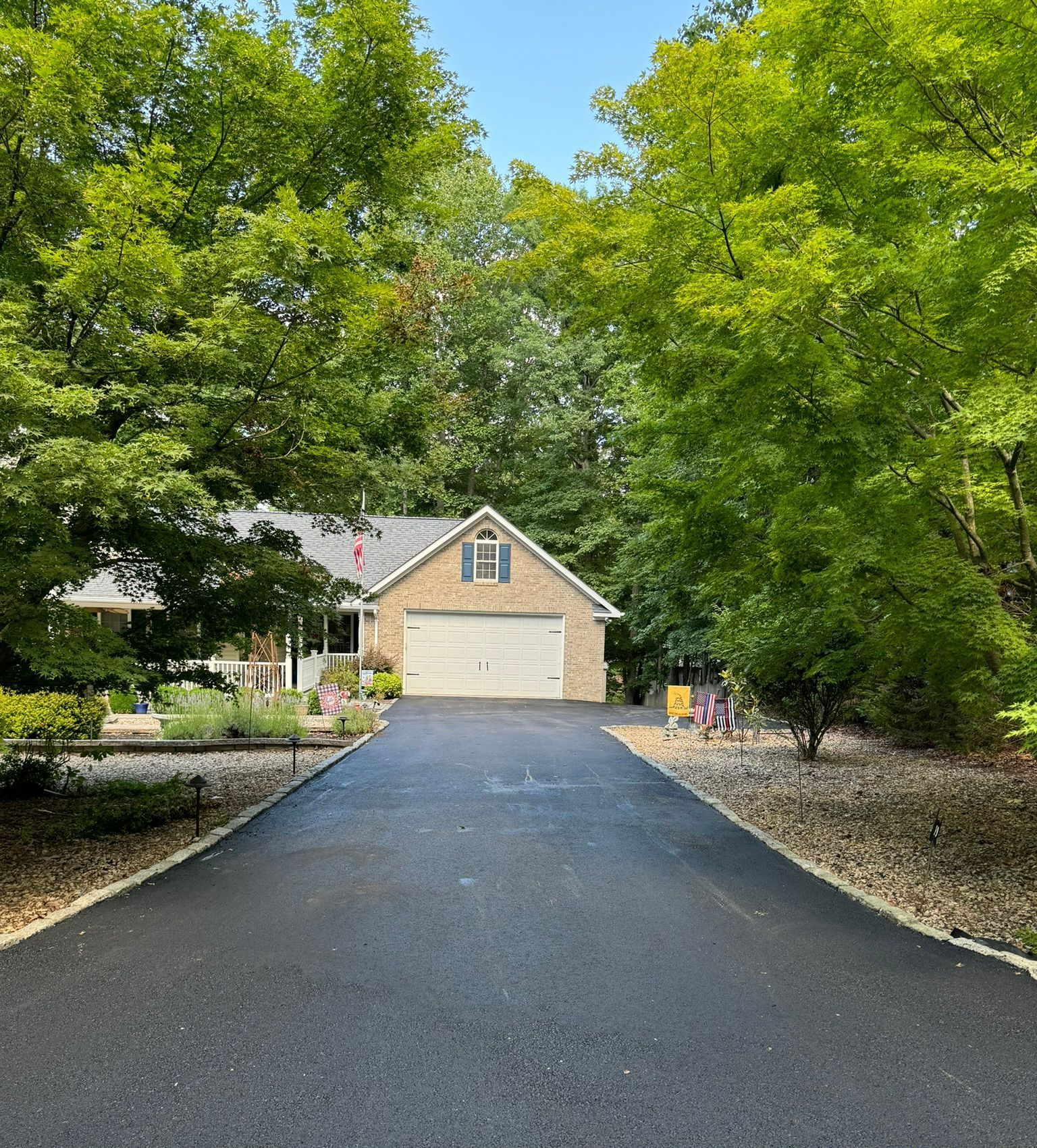 A man is working on a driveway with a bulldozer