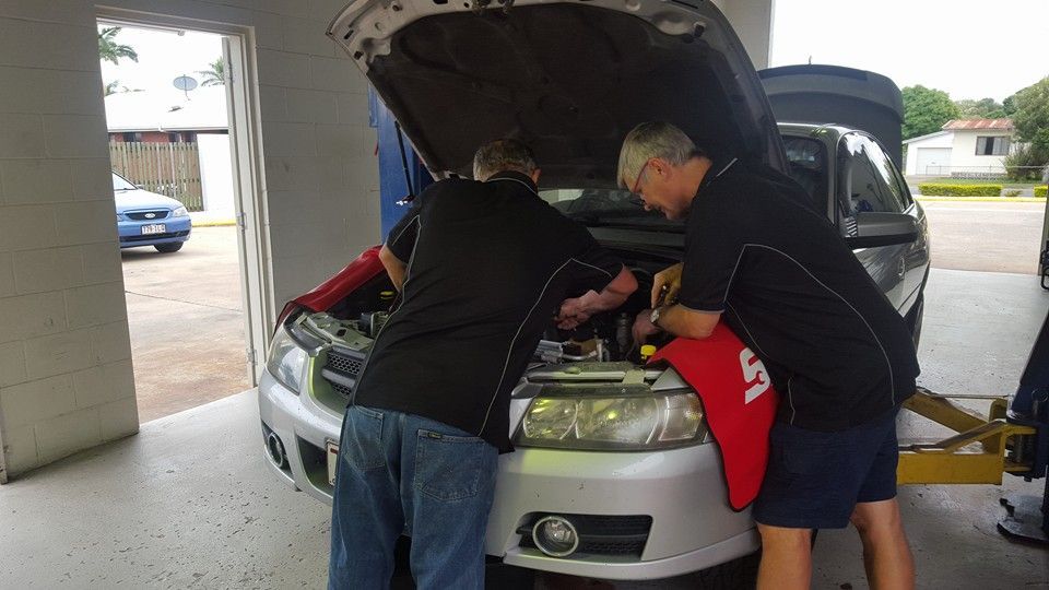 A Group of Men Are Working on a Car in a Garage — Mr Shiny Mechanical in Andergrove, QLD