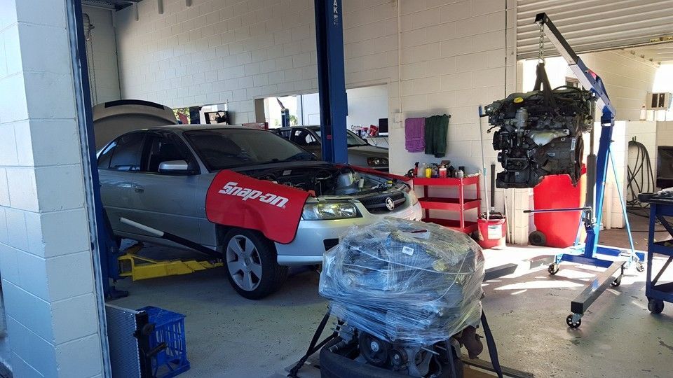 A Car is Sitting on a Lift in a Garage — Mr Shiny Mechanical in Andergrove, QLD