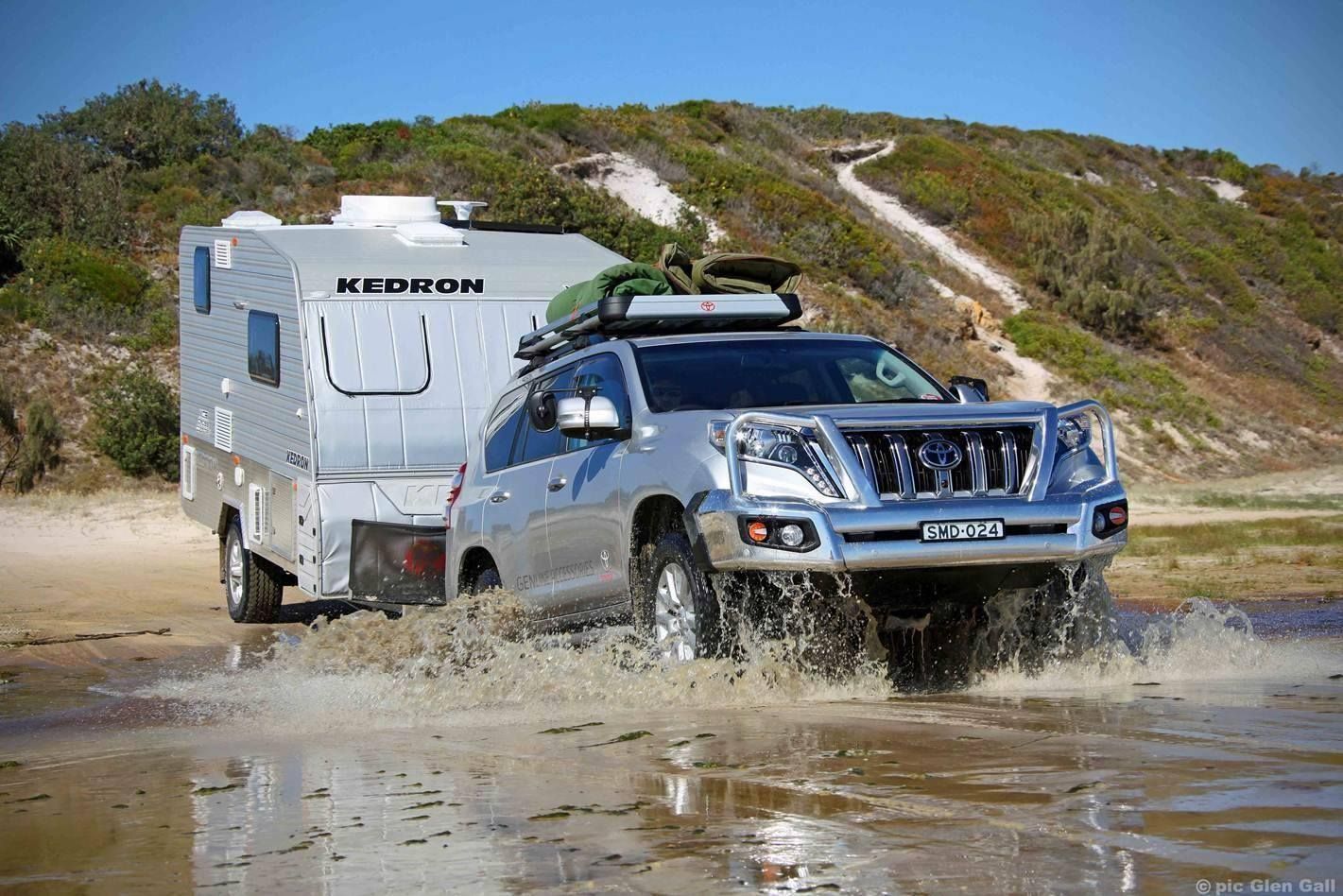 A Silver Suv is Driving Through a Muddy Area Next to a Trailer — Mr Shiny Mechanical in Andergrove, QLD
