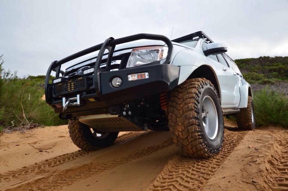 A White Truck is Driving Down a Dirt Road — Mr Shiny Mechanical in Kuttabul, QLD