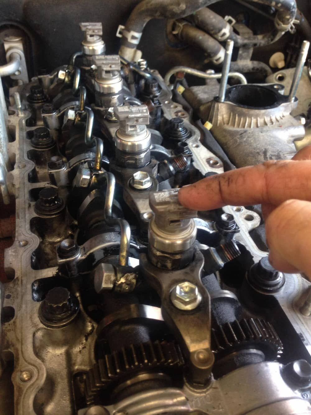 A Person is Pointing at a Part of a Car Engine — Mr Shiny Mechanical in Andergrove, QLD