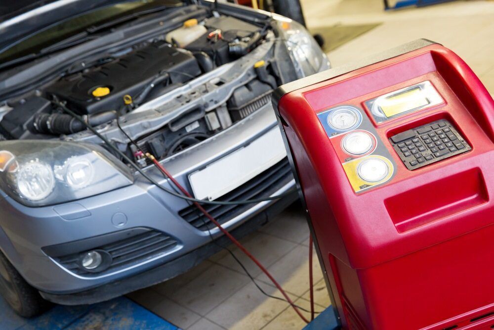 A Car is Being Serviced by a Mechanic in a Garage — Mr Shiny Mechanical in Sarina, QLD