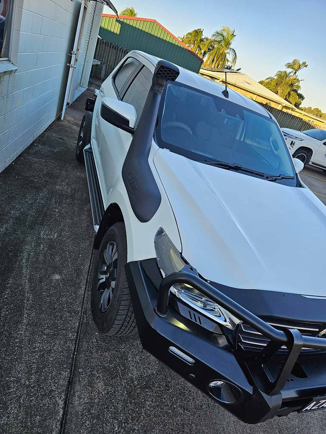 A White Suv With a Snorkel is Parked in Front of a Building — Mr Shiny Mechanical in Andergrove, QLD