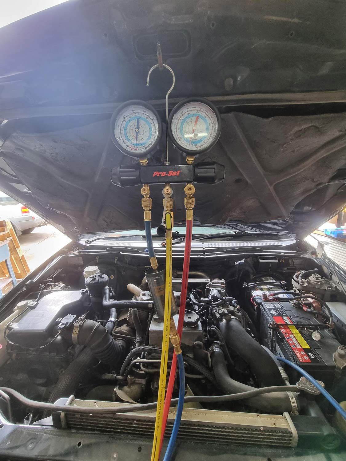 The Hood of a Car is Open and a Gauge is Hanging From It — Mr Shiny Mechanical in Andergrove, QLD