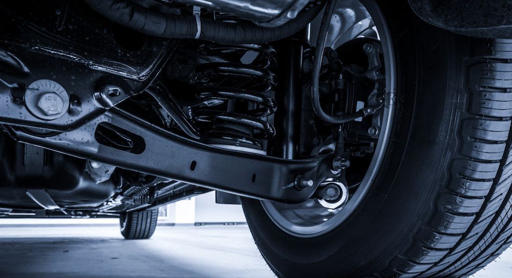 A Close Up of the Underside of a Car With a Tire — Mr Shiny Mechanical in Marian, QLD