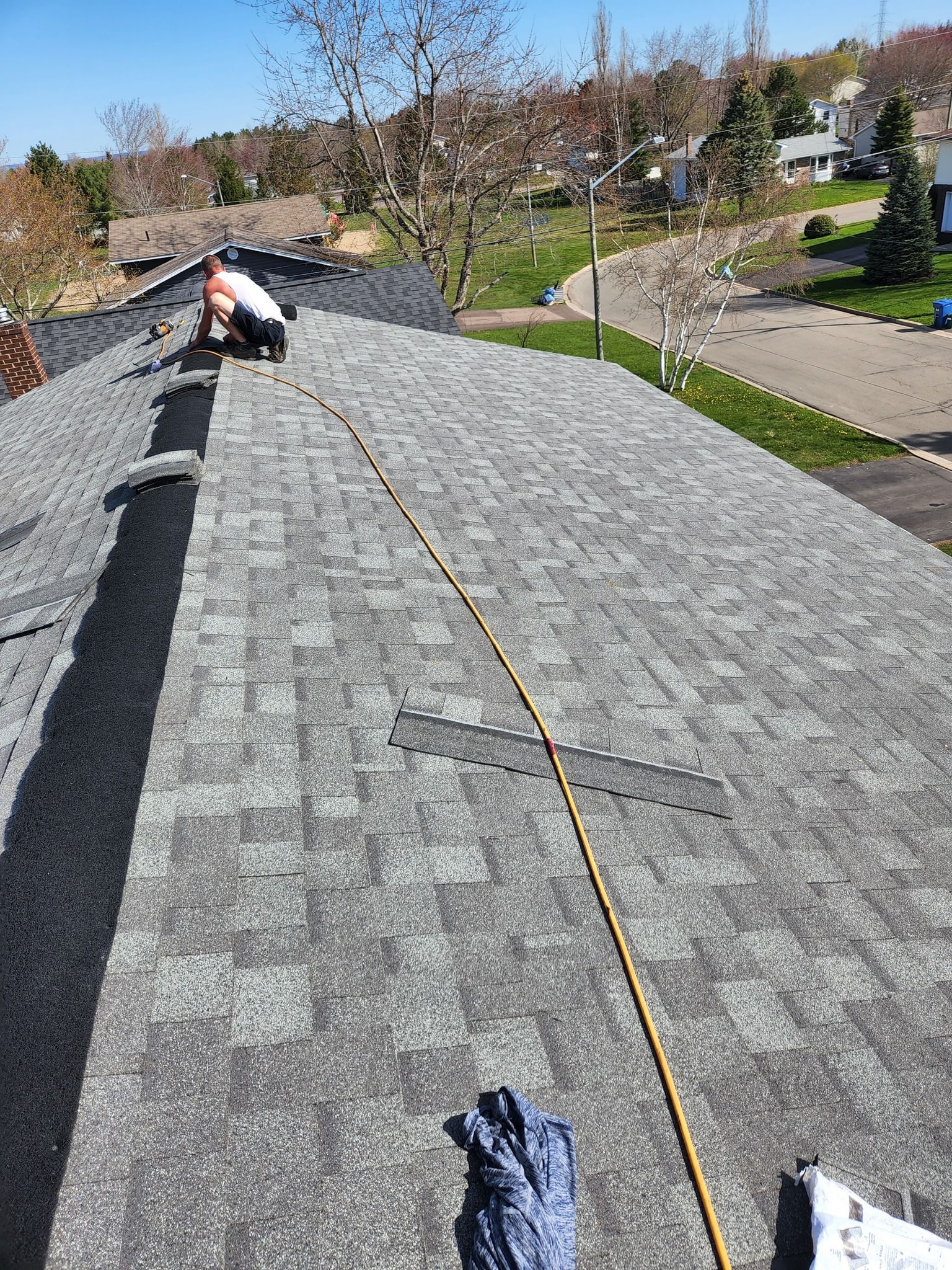 A man is working on the roof of a house.