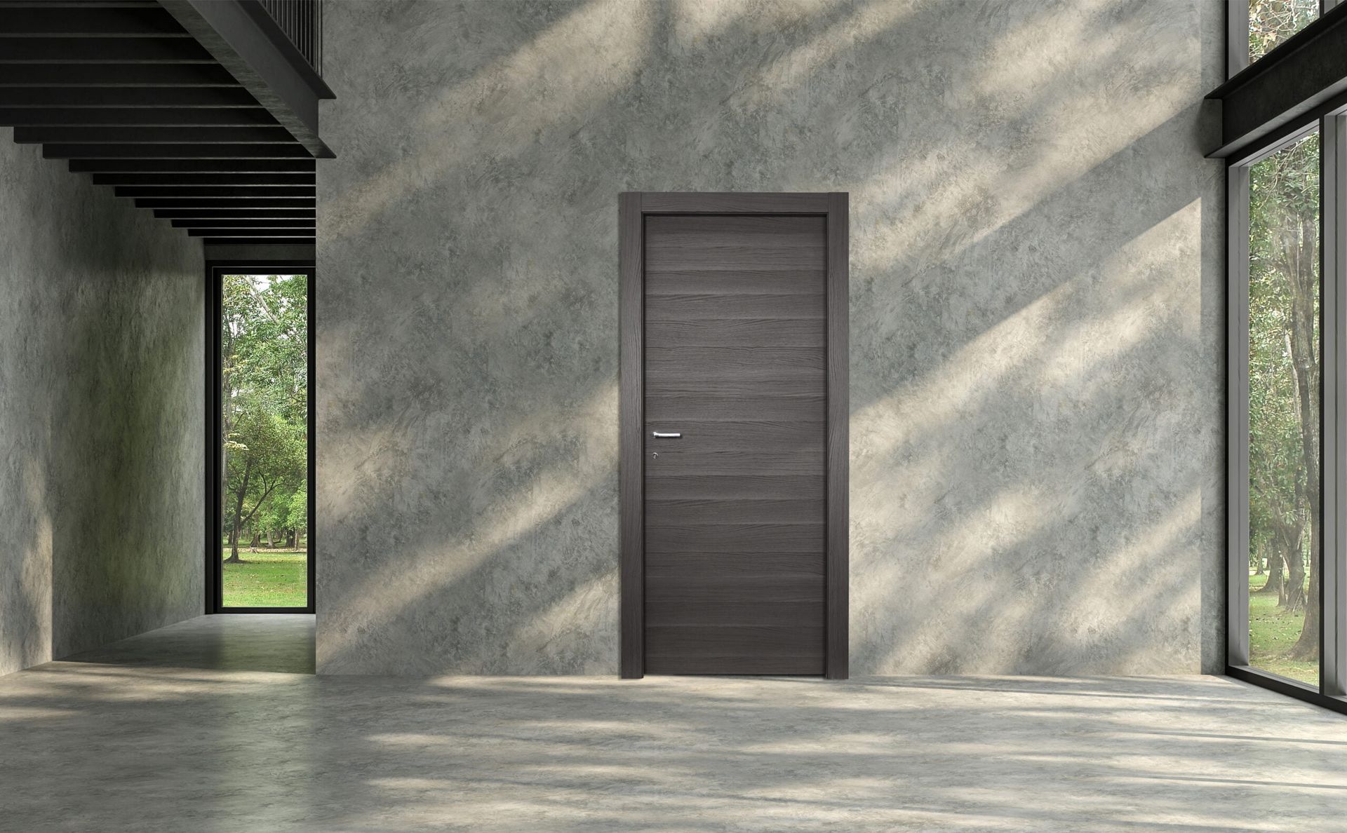 Interno moderno e minimalista con porta scura chiusa, pareti in cemento e ampie finestre con giochi di luce e ombre.