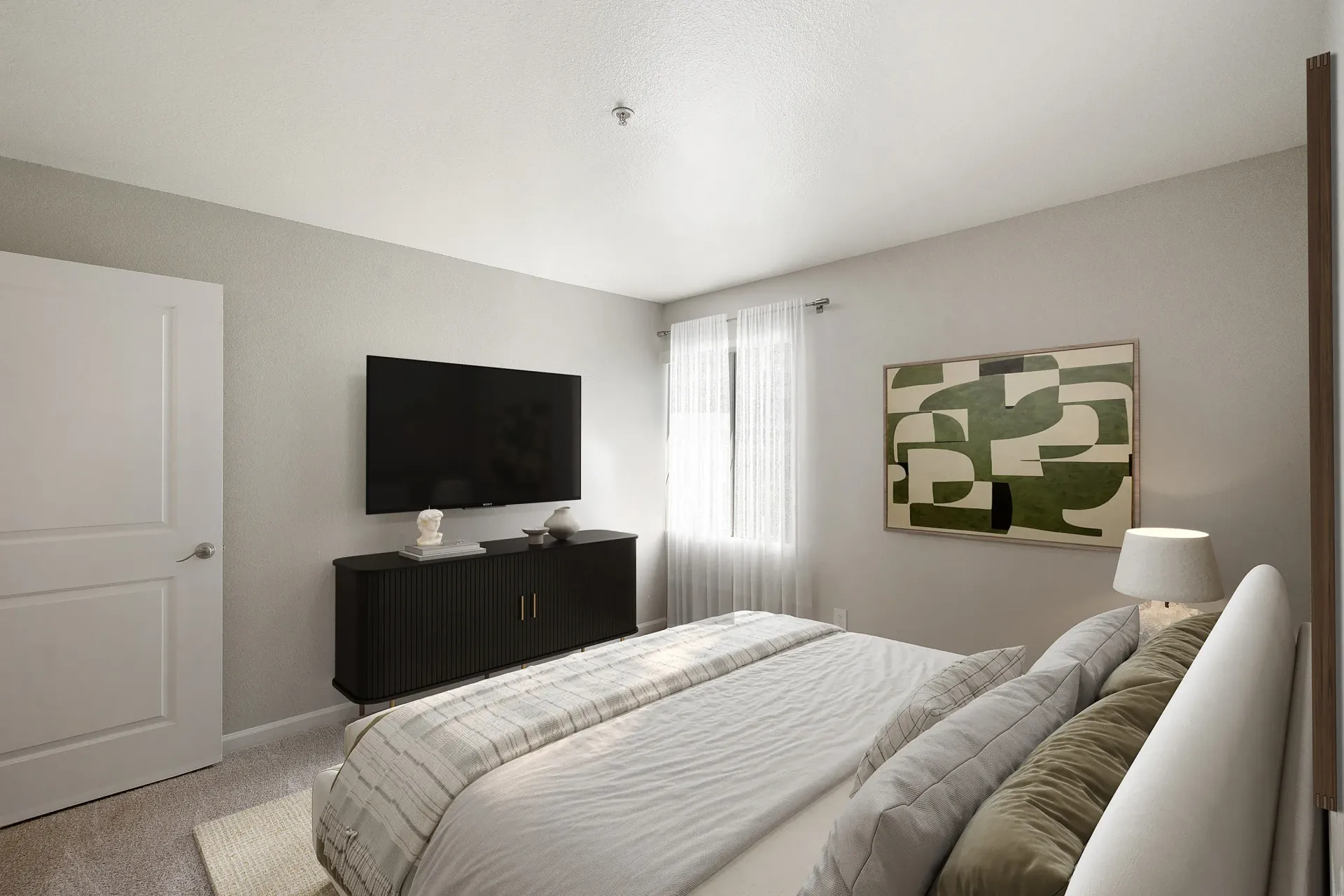 Bedroom with bed, TV on a low cabinet, window with sheer curtains and abstract wall art at Marina's Edge