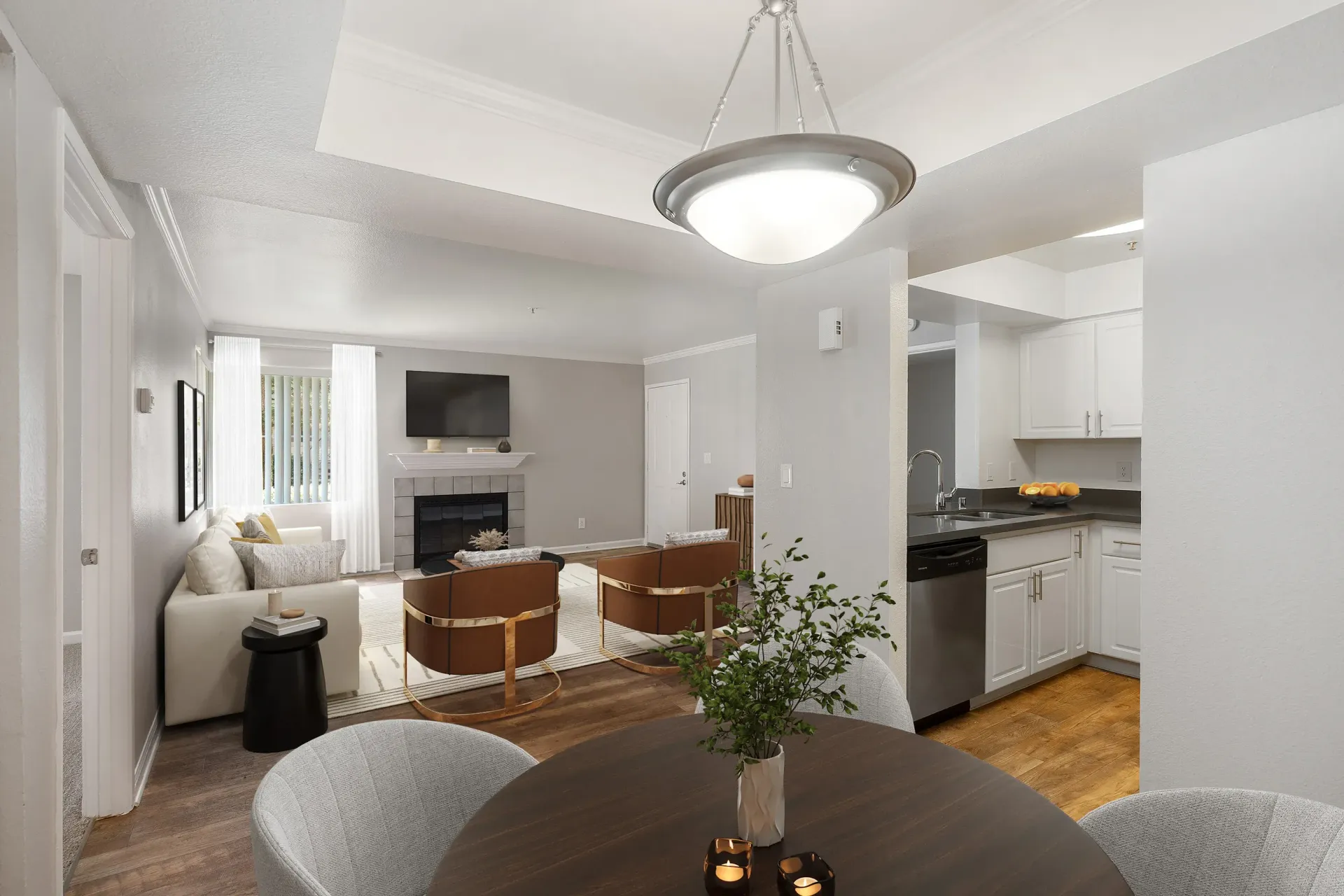 Open-concept living area with a sofa, fireplace, and view into the kitchen at Marina's Edge.