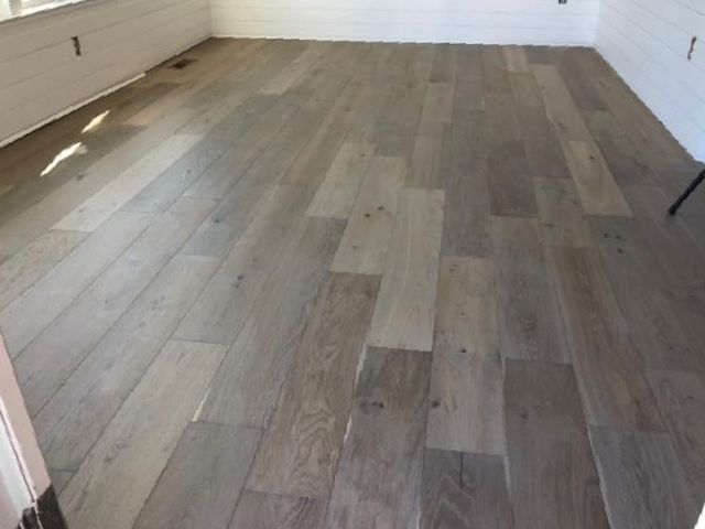 A room with a wooden floor and white walls
