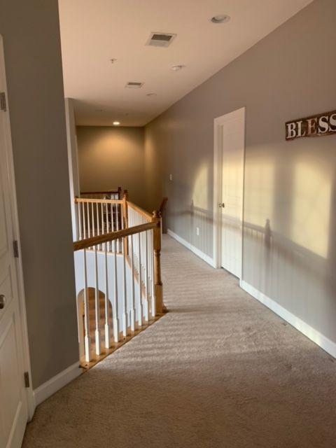 A hallway with a sign on the wall that says bless