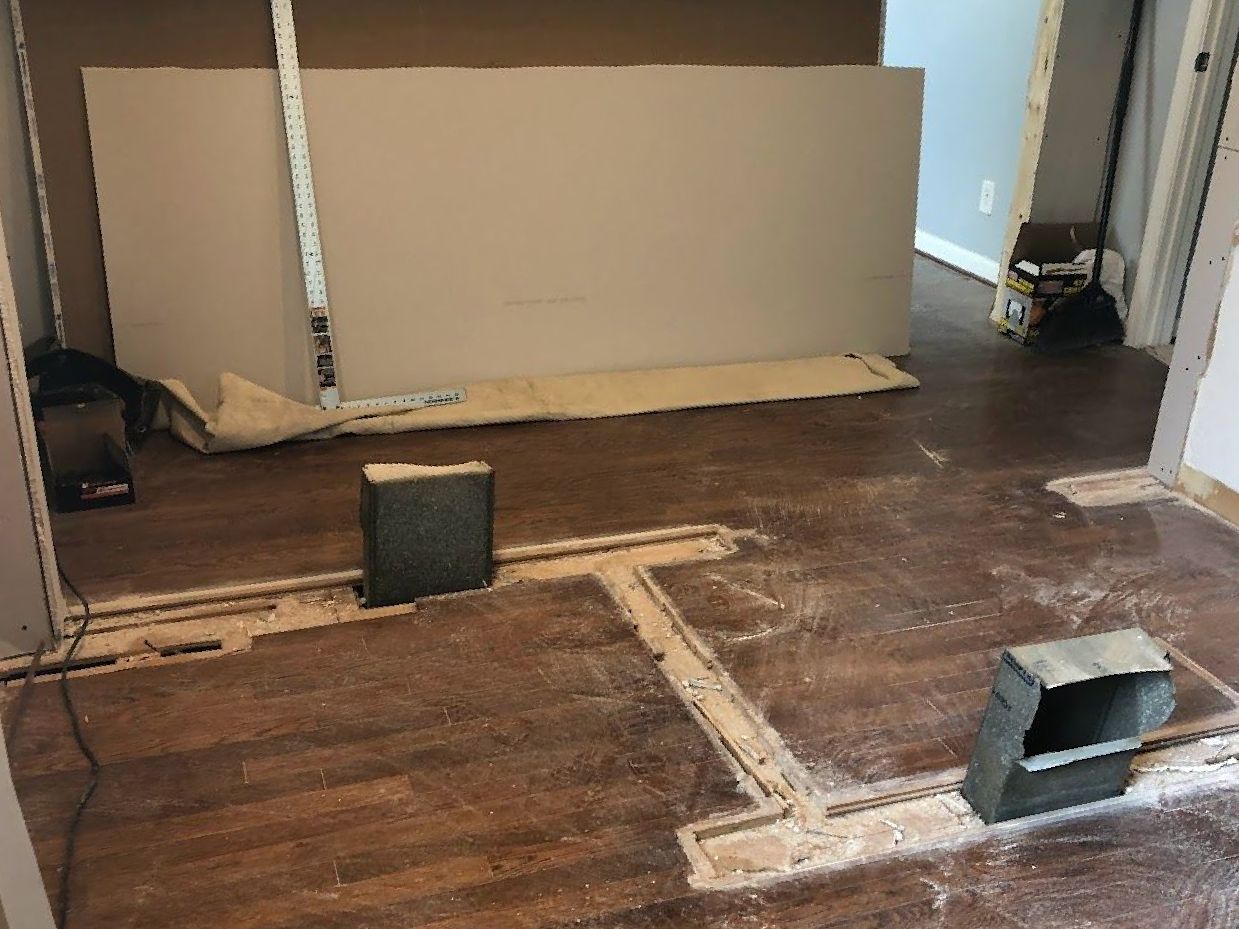 A room with a wooden floor and a box on the floor.