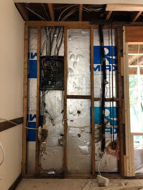 A room with a lot of wires coming out of the wall.