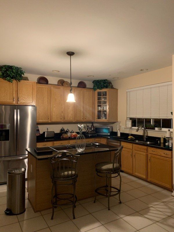 A kitchen with stainless steel appliances and wooden cabinets