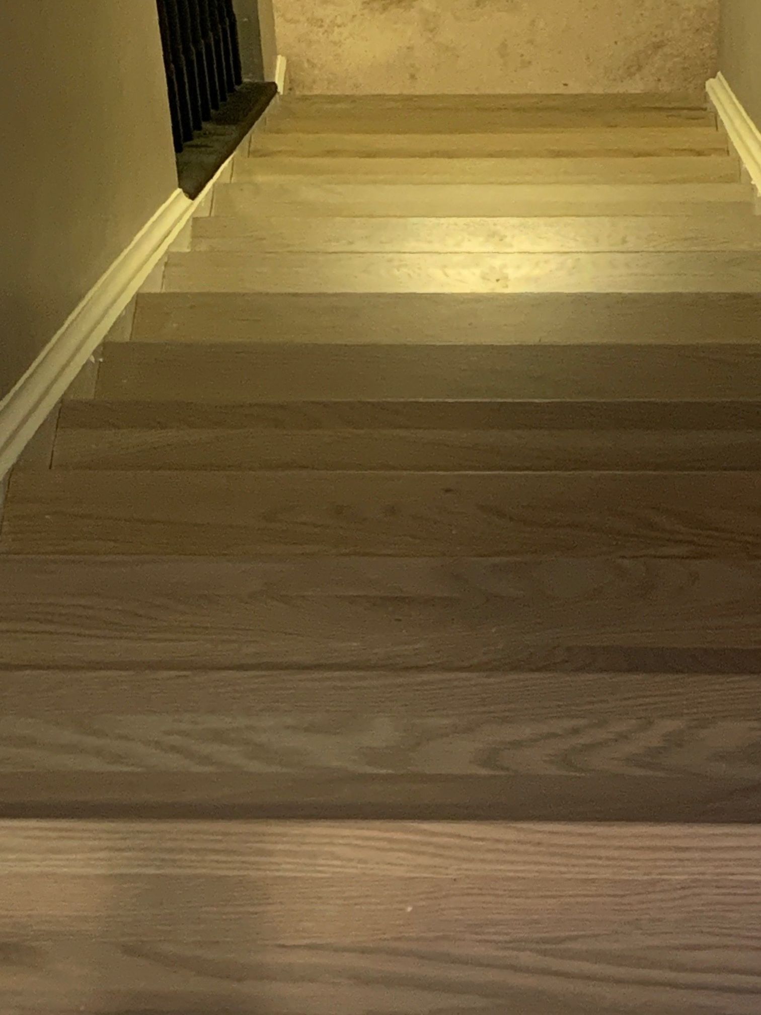 A close up of a wooden staircase in a house.