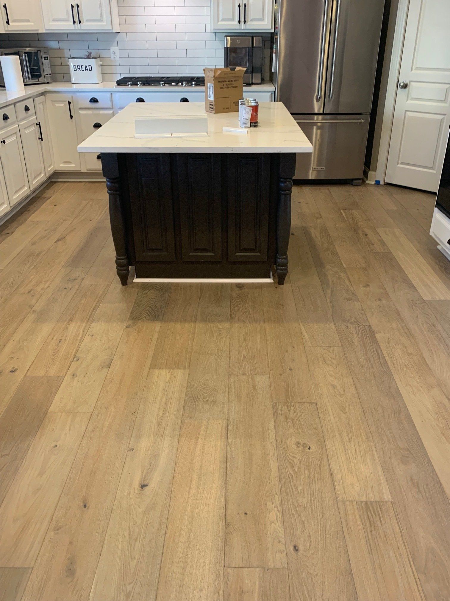 A kitchen with a large island in the middle of it.