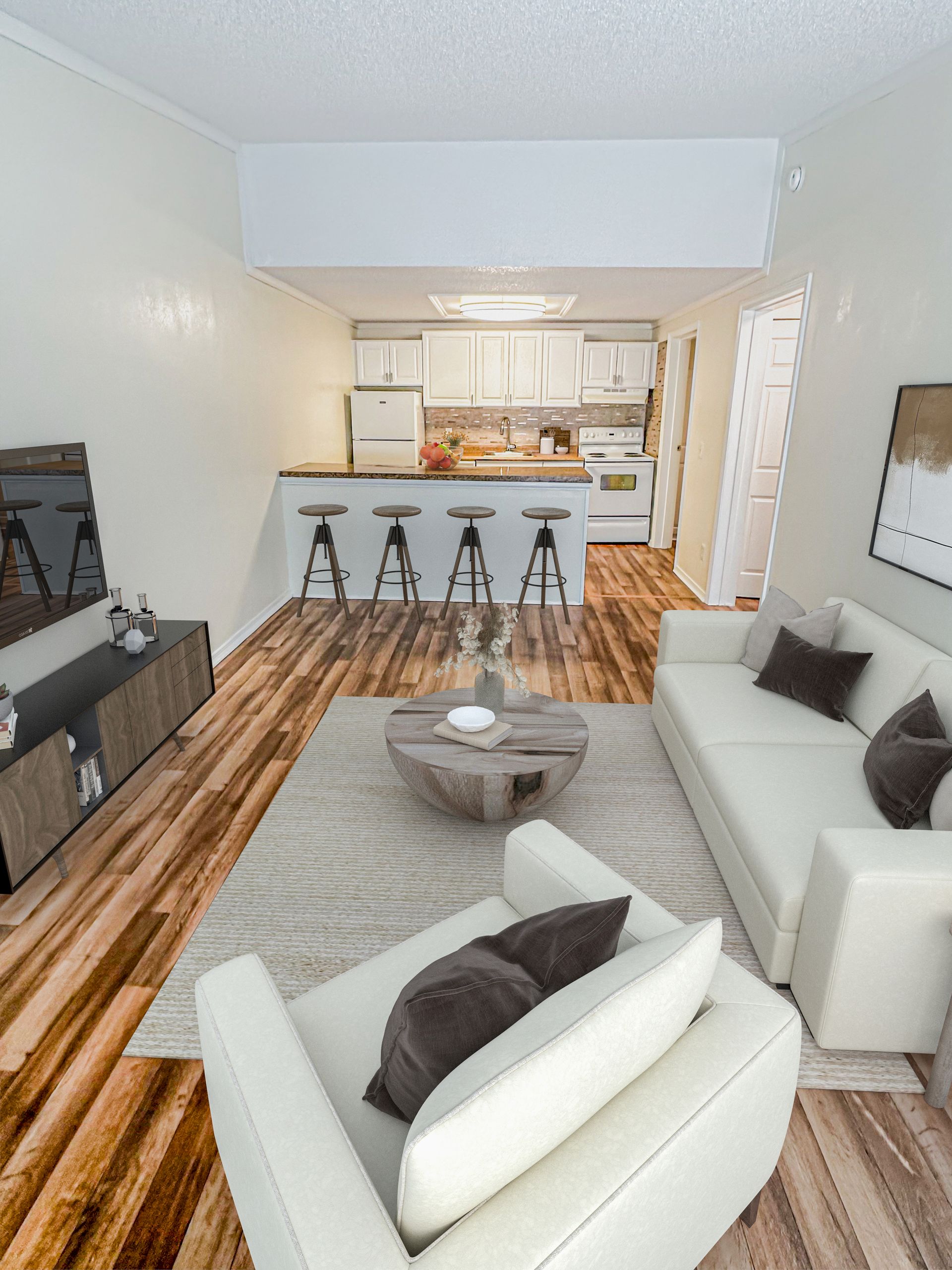 Photo of a smaller-size living room with a bartstool area seen in the background where the kitchen is