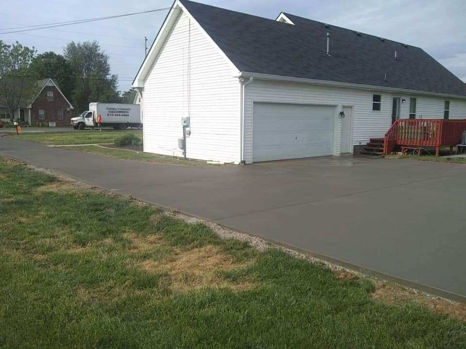 concrete driveway leading to a garage door