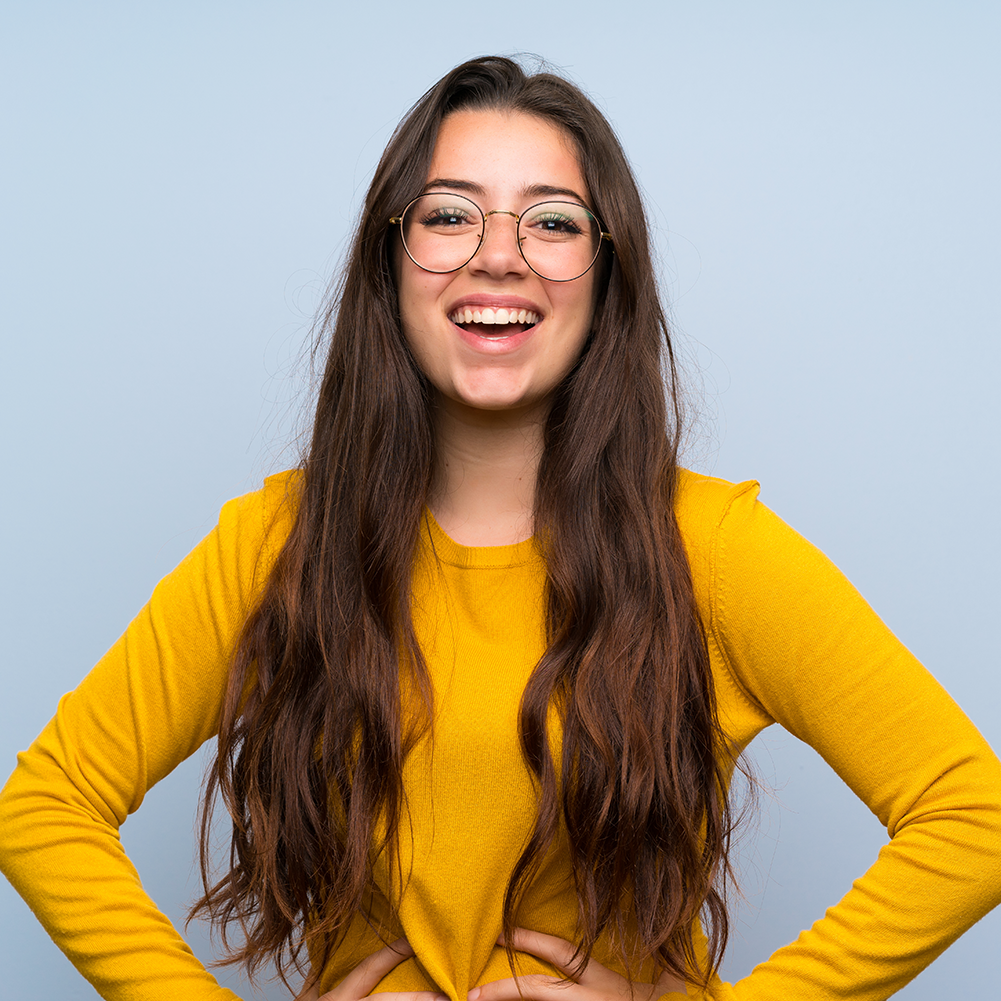 girl smiling with a big grin showing off her teeth