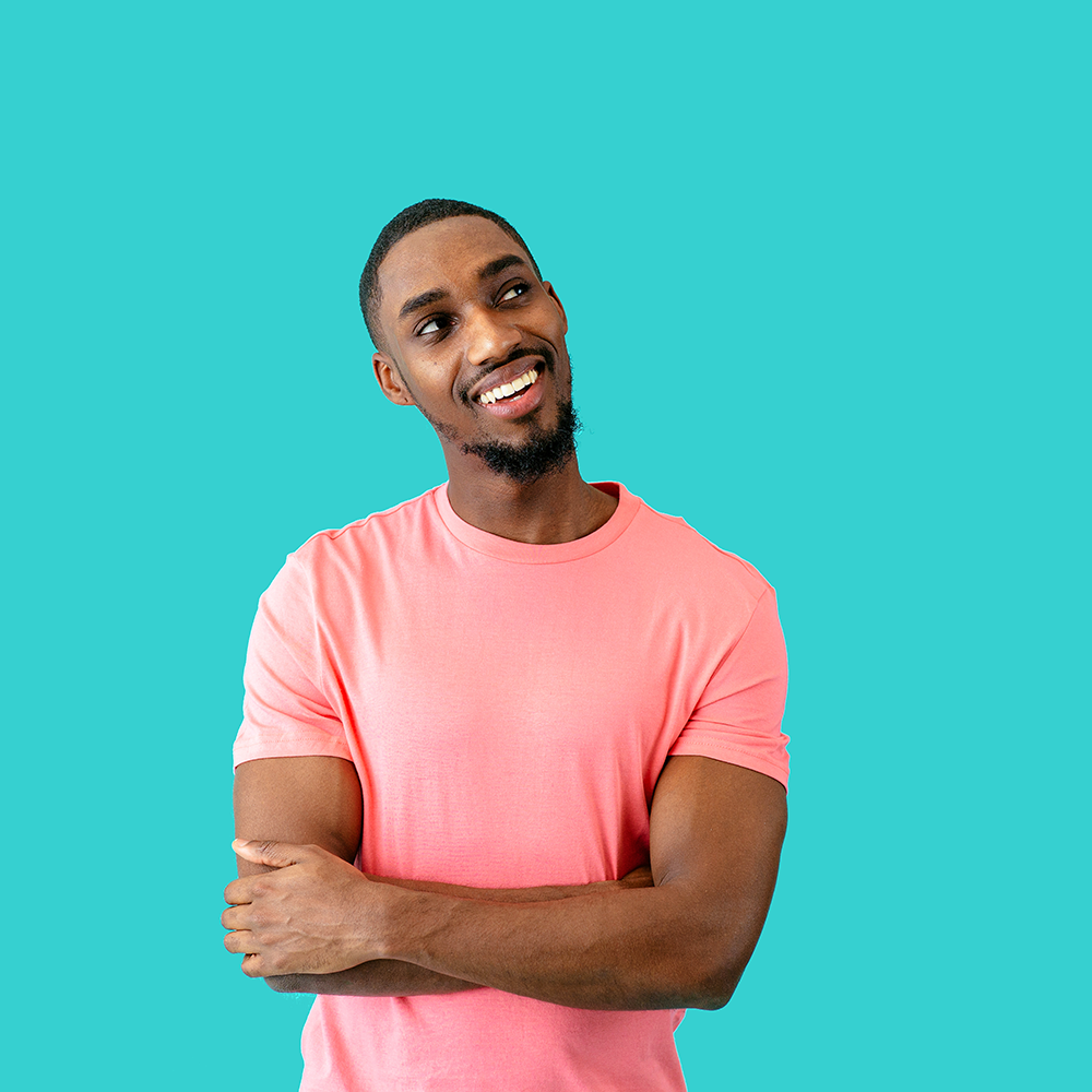 guy standing thinking smiling showing off his teeth