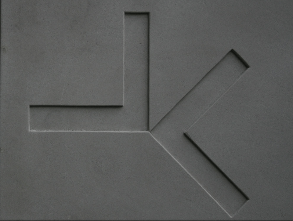Gray surface with carved geometric shape resembling a Y with an L at the top.
