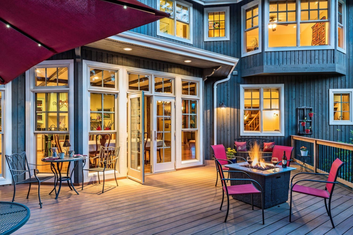 There is a fire pit on the deck of a house.