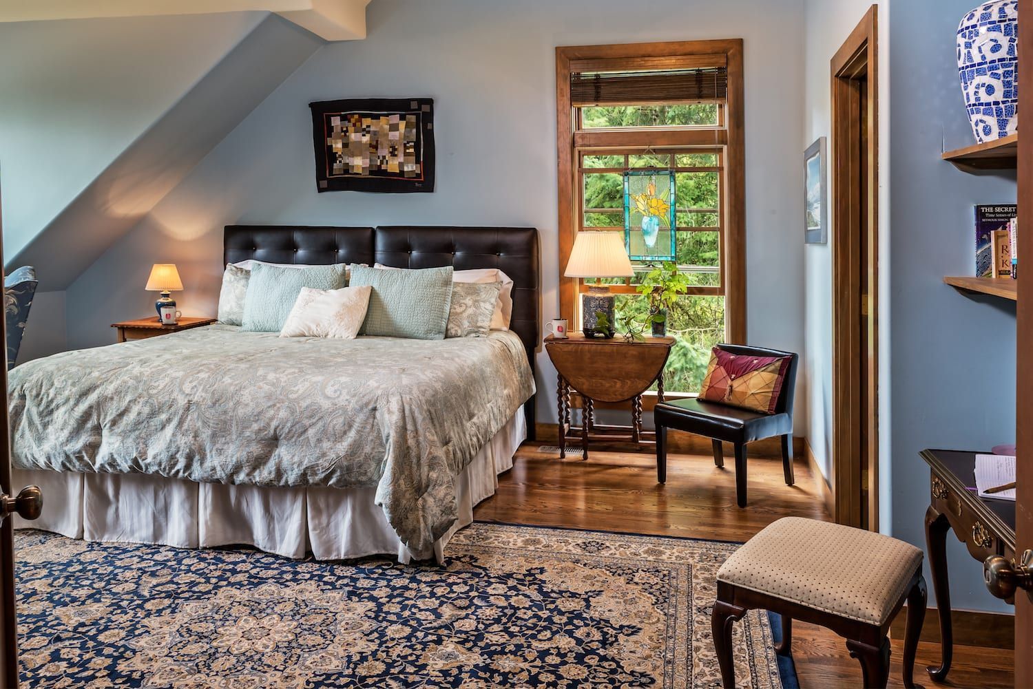 A bedroom with a king size bed and a rug