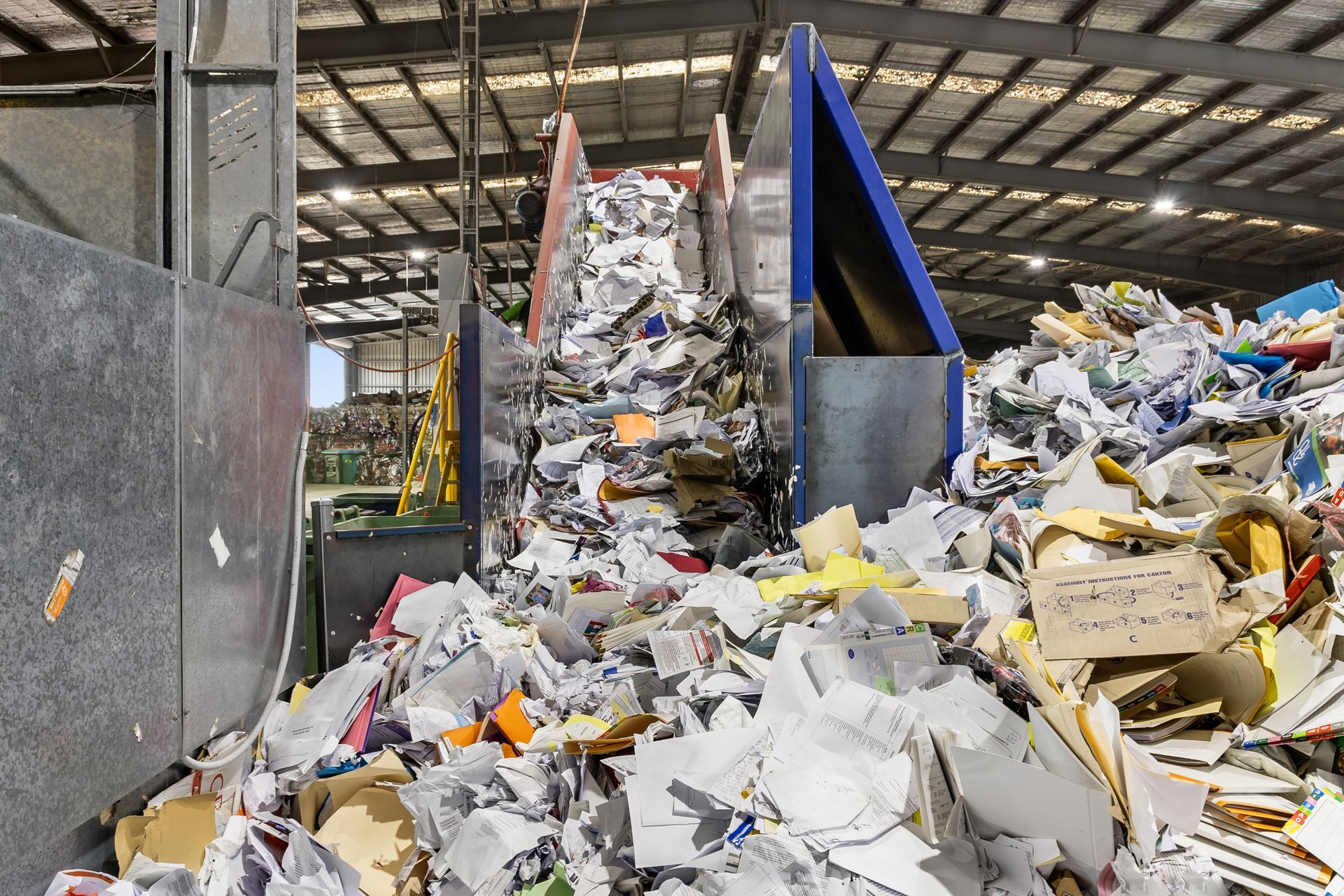 Bulk confidential paper records being securely destroyed and sorted for recycling at The DocShop's destruction facility.