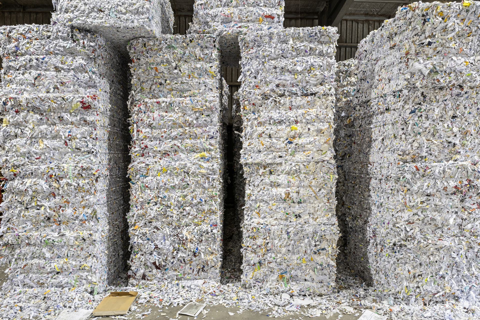 A warehouse filled with lots of cardboard stacked on top of each other.