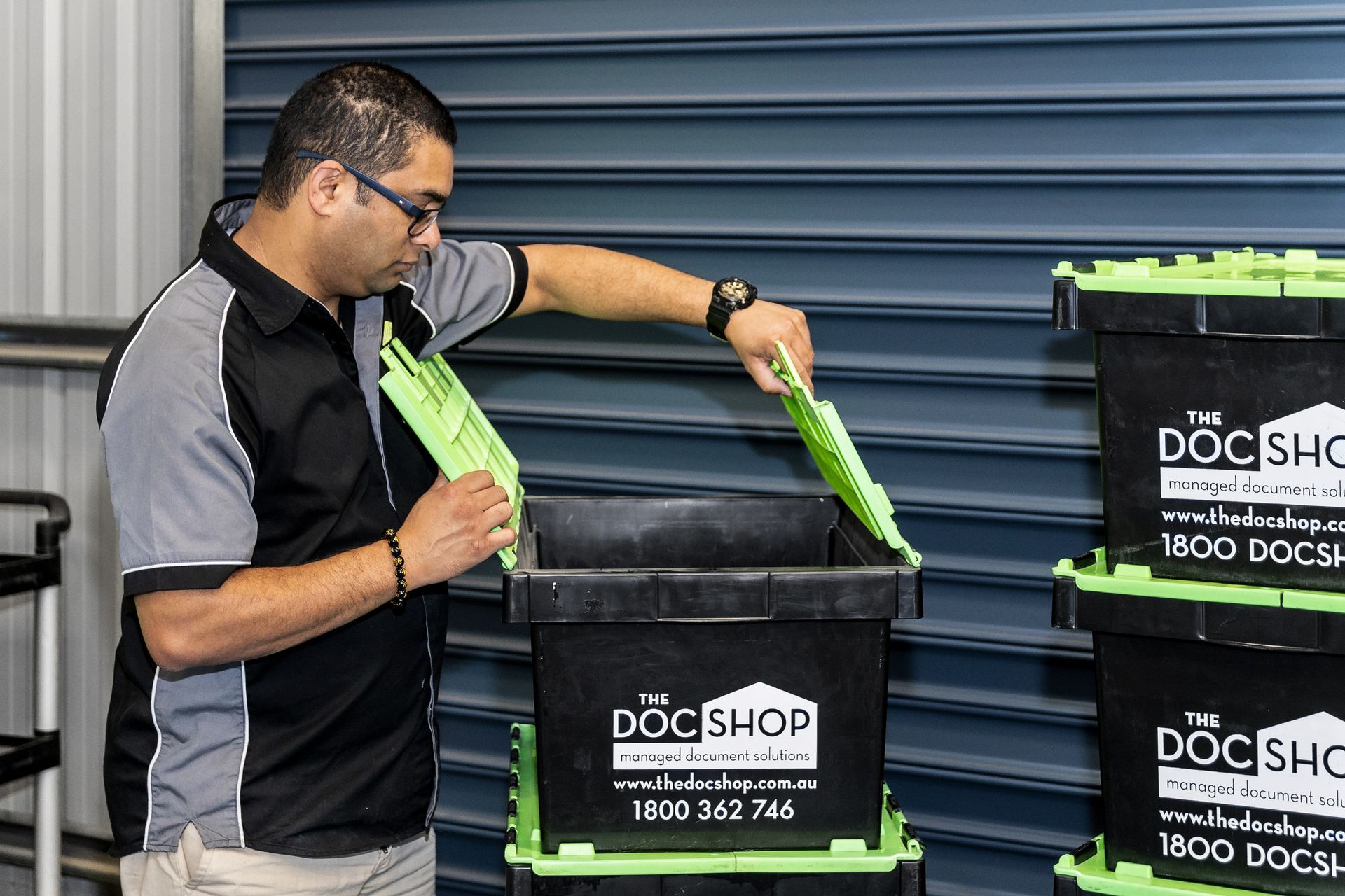 The DocShop team member securing confidential business records in moving crates during an office relocation.