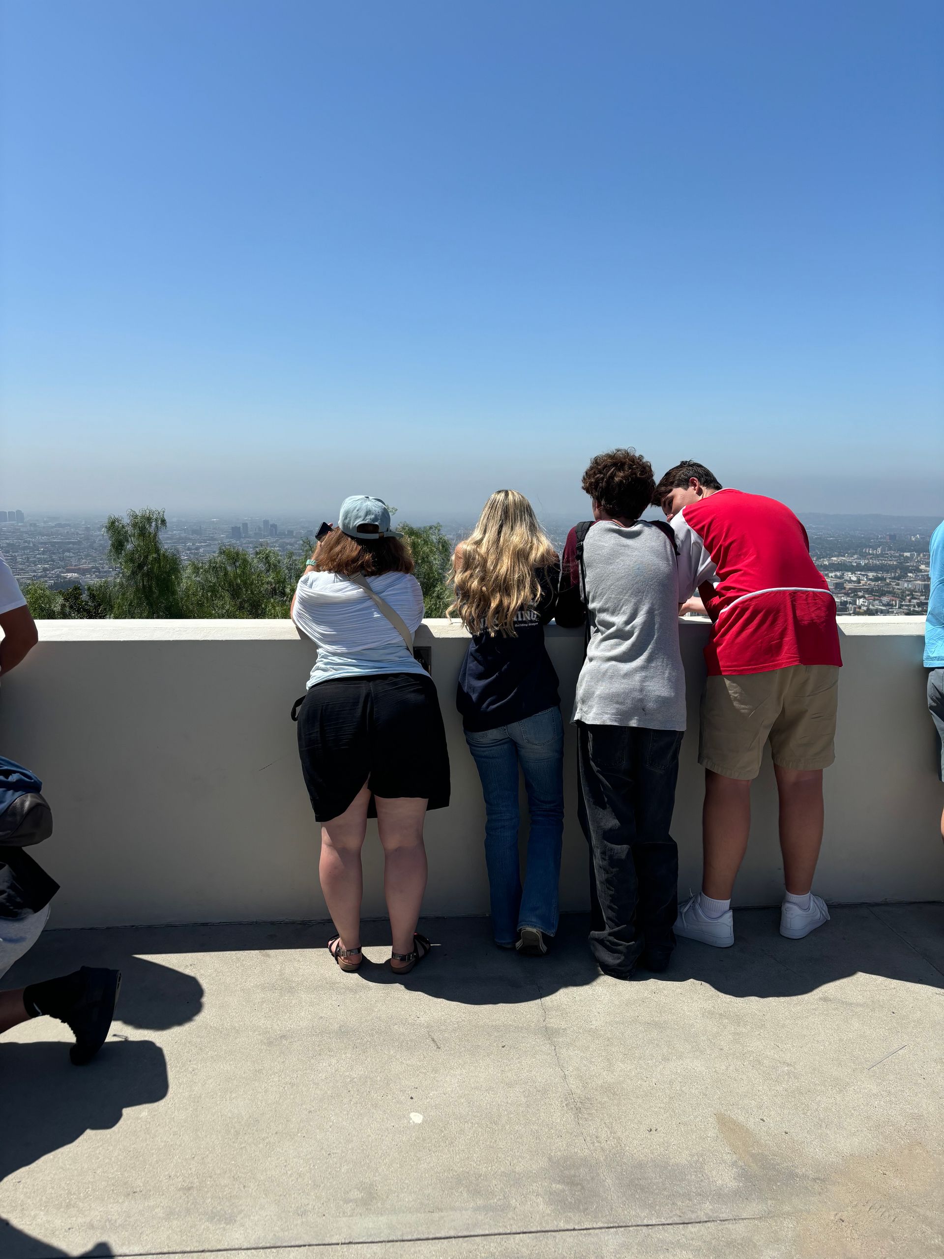 A group of people are looking out over a city
