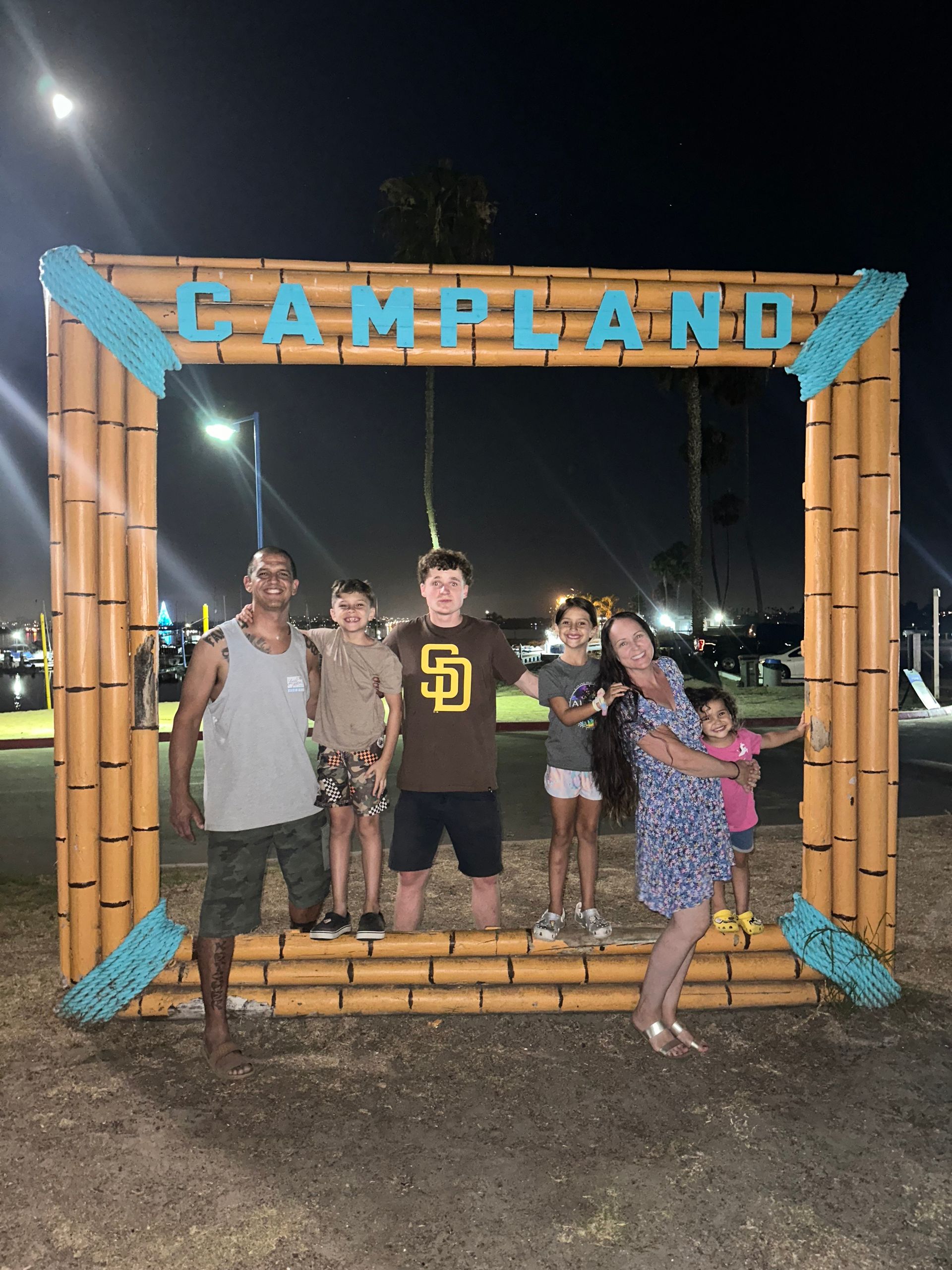 A group of people standing in front of a campland sign