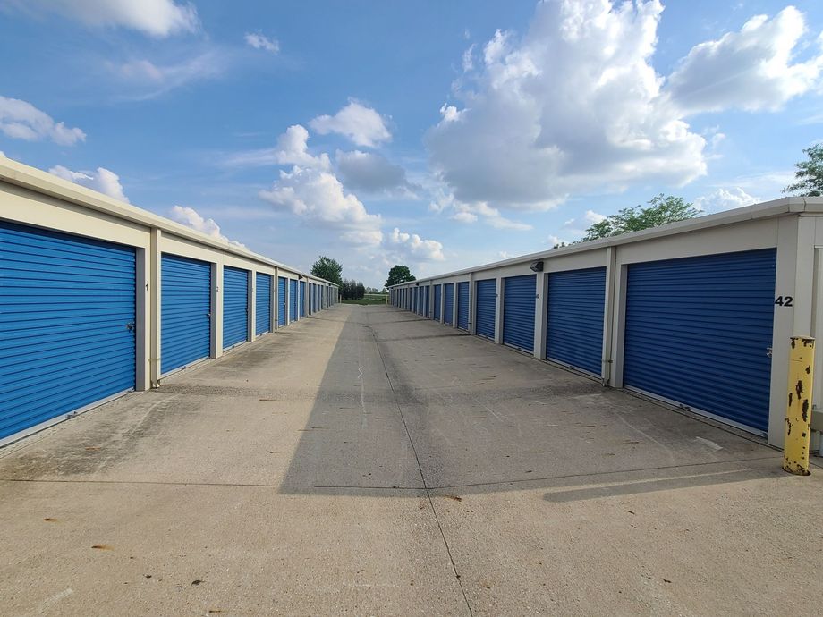 Secure storage units with blue doors in one building.