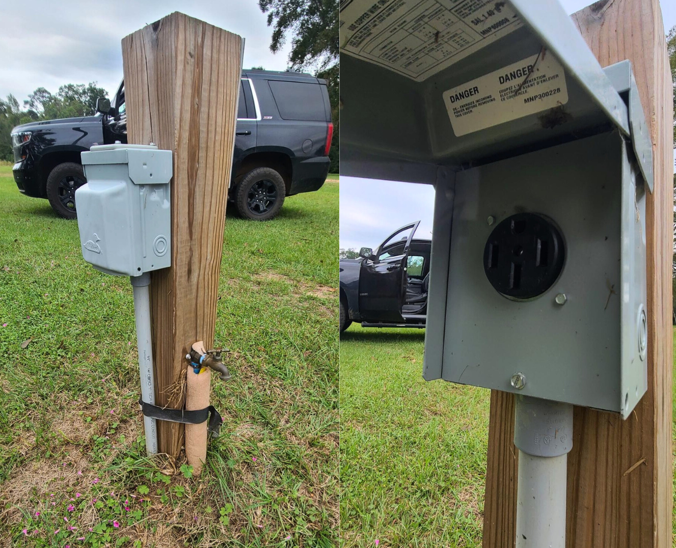 A truck is parked in the grass next to a wooden post with a box attached to it.