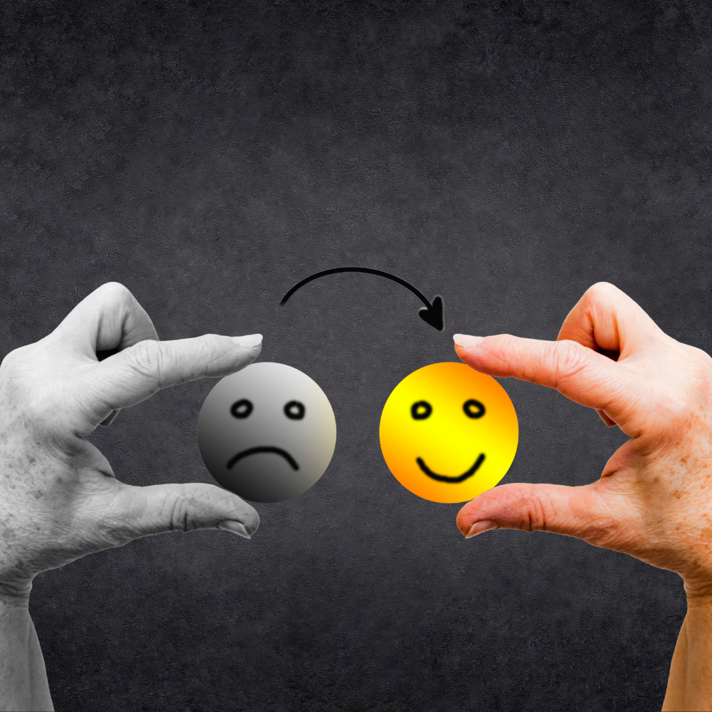Hands transforming a sad face into a happy face, indicating a shift in mood.