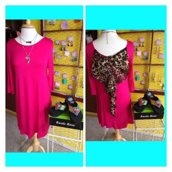 Two mannequin displays: hot pink dress front view and leopard-print back detail on a bright cyan background.