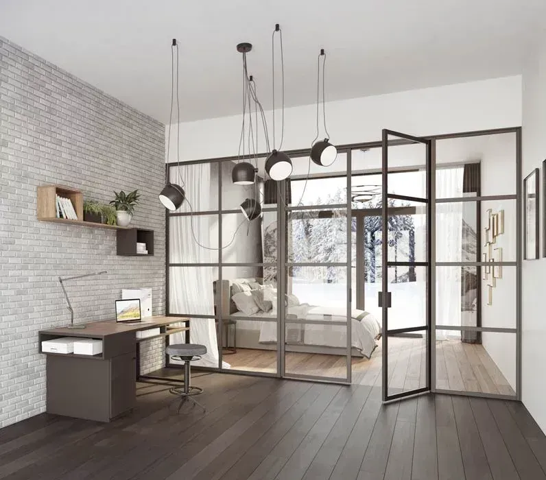 Une chambre avec une paroi vitrée entre la chambre et le bureau