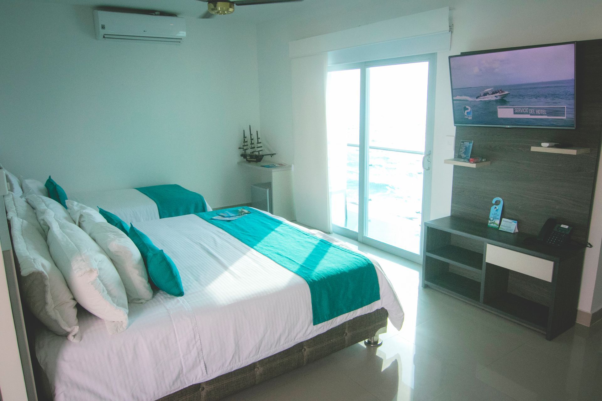 Bright hotel room with balcony and double bed for your family vacation at a top beach hotel in Coveñas Colombia