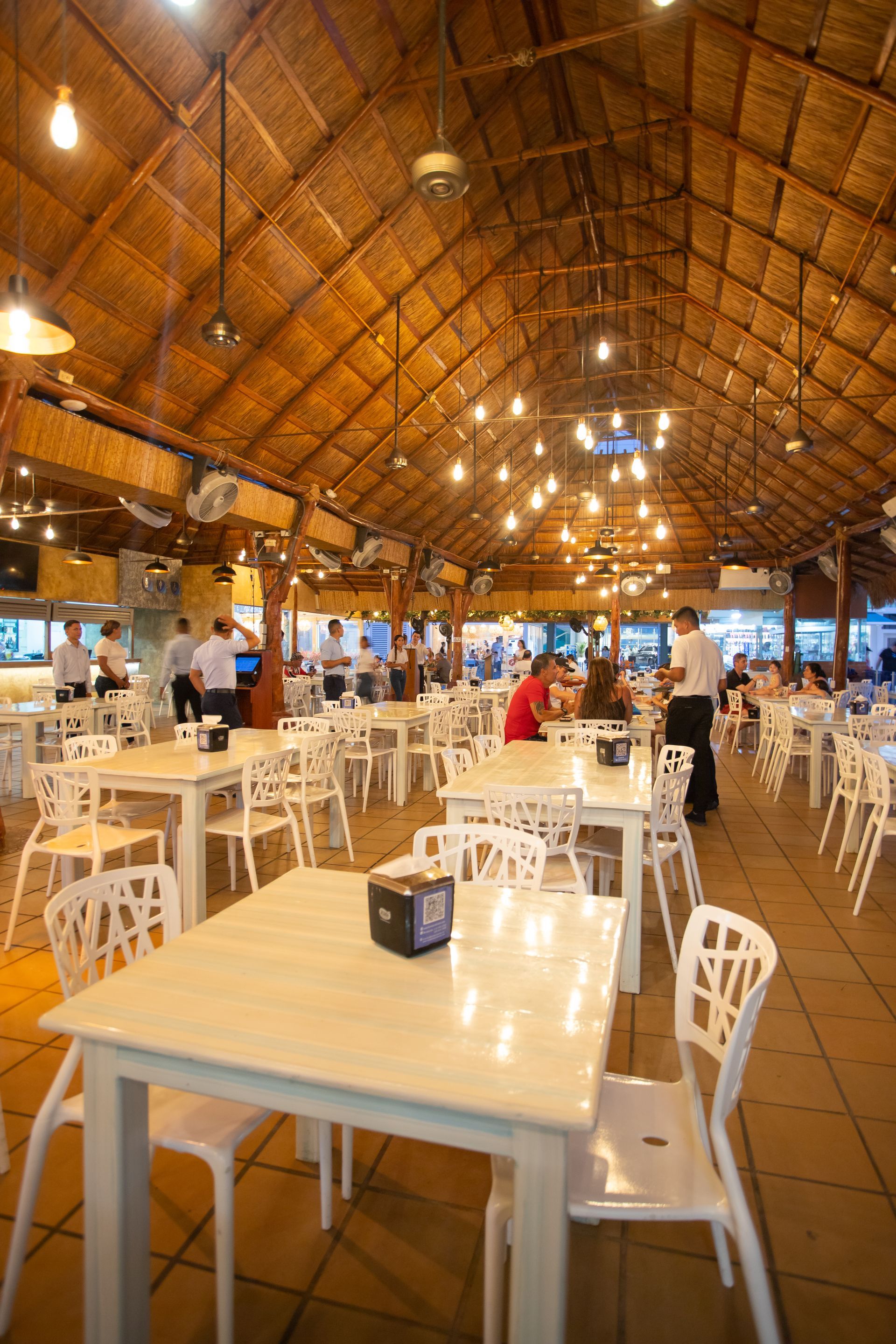 Roof with warm decorative hanging lights inside the restaurant at Coveñas in Hotel Poblado